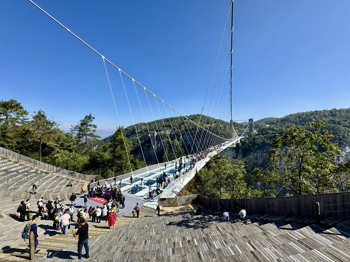 Visitors on the transparent deck of the Zhangjiajie Glass Bridge